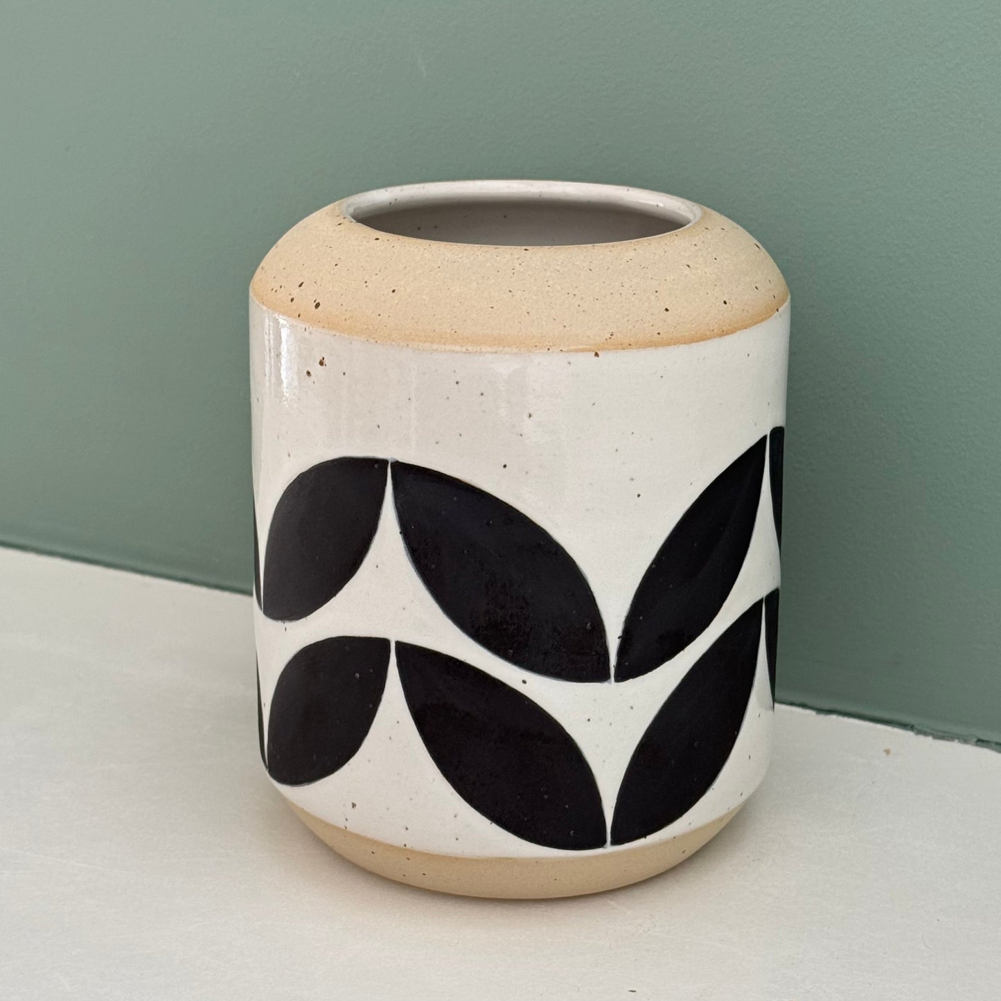 Vase, black leaves