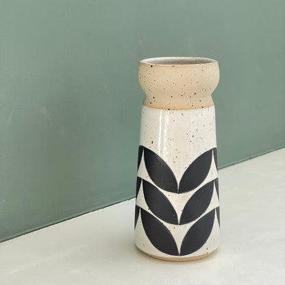 small vase, black leaves