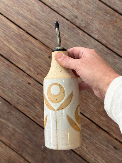 Oil bottle, exposed flower