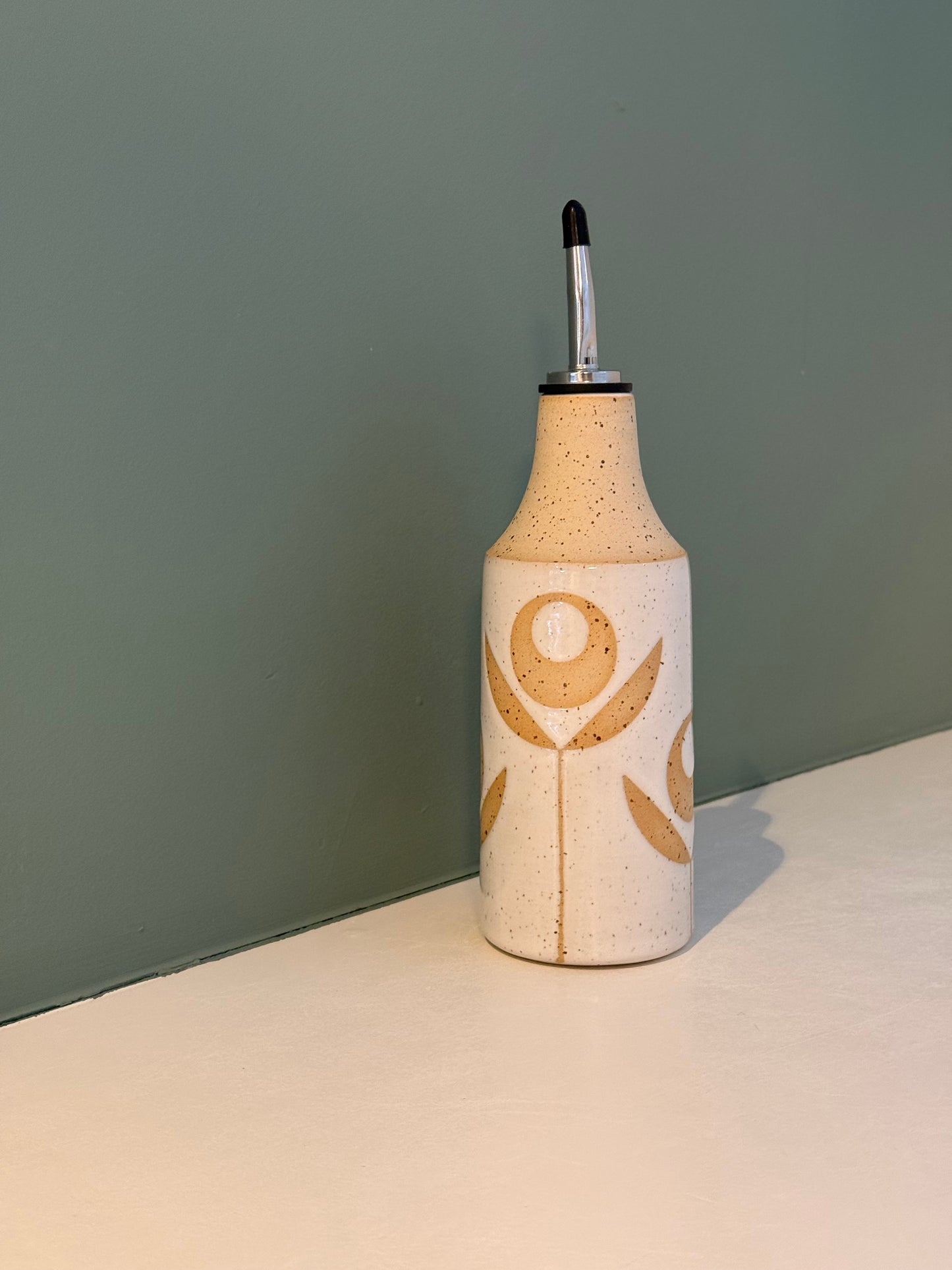 Oil bottle, exposed flower
