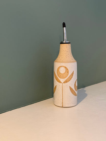 Oil bottle, exposed flower