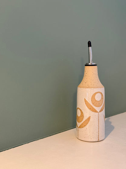 Oil bottle, exposed flower